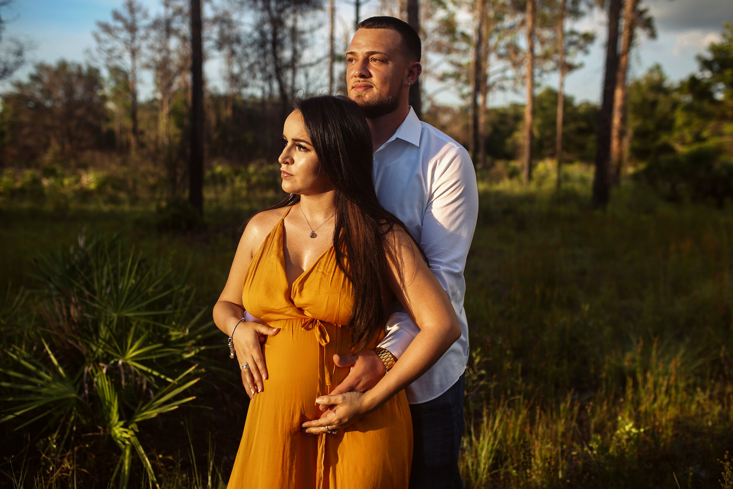 Rustic maternity photos in Tampa Expecting Mom and family in front of barn