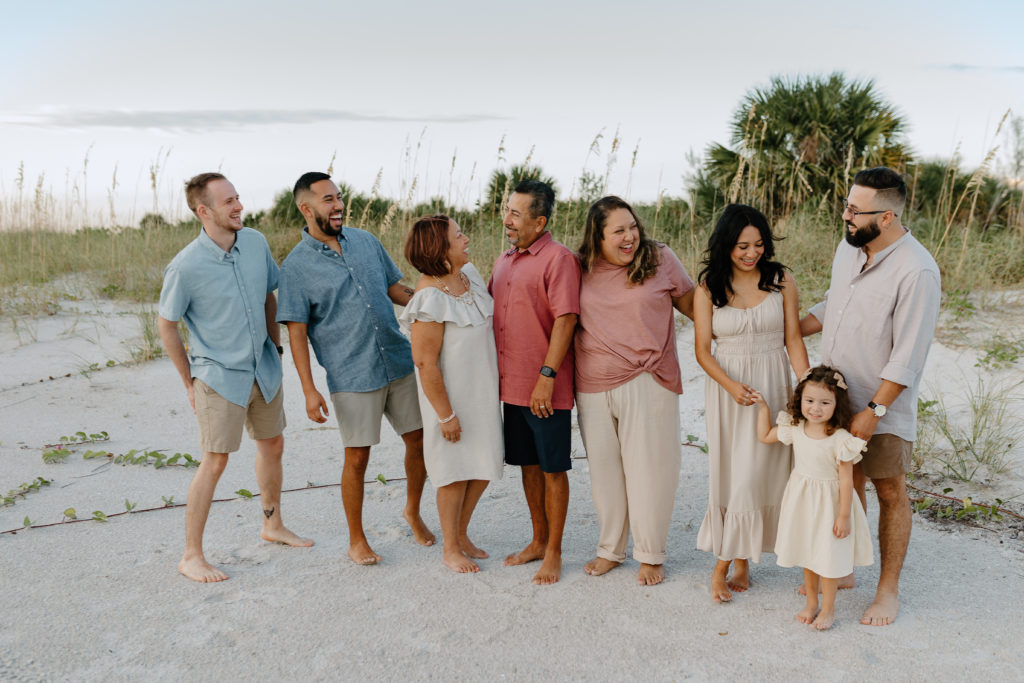 An extended family laughing together on the beach in Treasure Island, Florida by Michelle Medina Photography. 