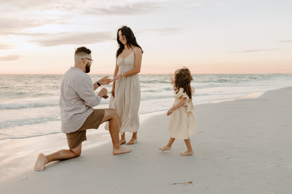 A special moment between family during a proposal by Michelle Medina Photography. 